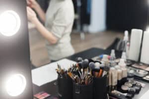 Makeup brushes cosmetics near mirror