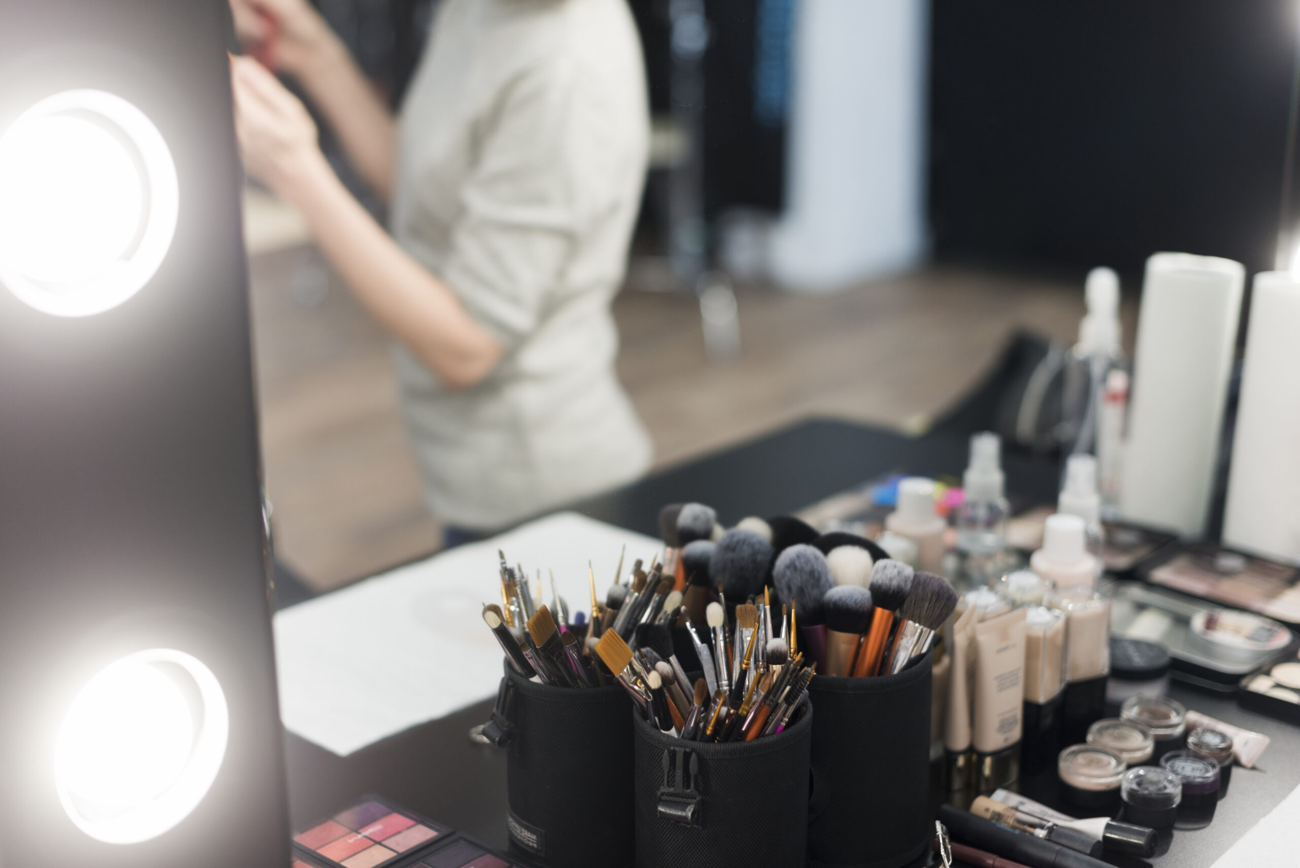 Makeup brushes cosmetics near mirror